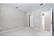 Spacious bedroom with neutral carpet and white trim with views to an entry and the main part of the house at 1596 Laurel Brook Ln, Port Charlotte, FL 33953