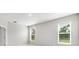 Bedroom with neutral walls, carpet flooring, and two windows with blinds, creating a bright and serene atmosphere at 1596 Laurel Brook Ln, Port Charlotte, FL 33953