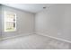 Bedroom featuring carpet flooring, neutral walls and a large window at 1596 Laurel Brook Ln, Port Charlotte, FL 33953