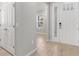 Bright entryway featuring light wood flooring and a modern front door with glass panels at 1596 Laurel Brook Ln, Port Charlotte, FL 33953
