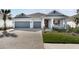 Charming single-story home featuring a two-car garage and a beautifully landscaped front yard at 1596 Laurel Brook Ln, Port Charlotte, FL 33953