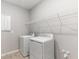 Functional laundry room with washer, dryer, and wire shelving for convenient storage at 1596 Laurel Brook Ln, Port Charlotte, FL 33953