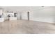 Open-concept living room featuring tile flooring connected to a bright kitchen with an island and modern appliances at 1596 Laurel Brook Ln, Port Charlotte, FL 33953