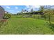 Expansive backyard features lush green grass, a wrought iron fence and lounge chairs at 16226 Paynes Mill Dr, Bradenton, FL 34211