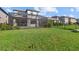 Expansive backyard with screen enclosure, pool, and well-maintained lawn at 16226 Paynes Mill Dr, Bradenton, FL 34211