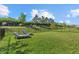 Spacious backyard featuring a lush lawn, fence, and two lounge chairs at 16226 Paynes Mill Dr, Bradenton, FL 34211