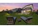 Relax in the backyard with two lounge chairs overlooking the home's screened-in pool at 16226 Paynes Mill Dr, Bradenton, FL 34211