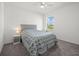 Bright bedroom featuring a comfortable bed, side table and natural light at 16226 Paynes Mill Dr, Bradenton, FL 34211