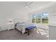Serene bedroom with ceiling fan, bench, and view to backyard at 16226 Paynes Mill Dr, Bradenton, FL 34211