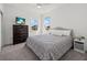 Bedroom features a comfortable bed, large windows, ceiling fan, and television at 16226 Paynes Mill Dr, Bradenton, FL 34211