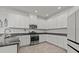 Bright kitchen features stainless steel appliances, gray granite countertops, and white cabinets at 16226 Paynes Mill Dr, Bradenton, FL 34211