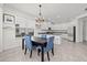 Bright kitchen features an island with granite countertops and stainless steel appliances, and a dining area with chandelier at 16226 Paynes Mill Dr, Bradenton, FL 34211
