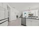 Open kitchen with stainless steel appliances and eat-in nook overlooking the staircase and living room at 16226 Paynes Mill Dr, Bradenton, FL 34211