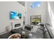 Spacious living room with high ceilings, fireplace, large TV, and sliding glass doors to outdoor patio at 16226 Paynes Mill Dr, Bradenton, FL 34211