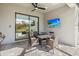 Covered patio area featuring a table and chairs, television and view to pool at 16226 Paynes Mill Dr, Bradenton, FL 34211