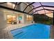 A screened-in pool with an outdoor dining area is ideal for entertaining and relaxation at 16226 Paynes Mill Dr, Bradenton, FL 34211