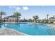 Large community pool with shallow entry, lounge chairs, and poolside dining at 16226 Paynes Mill Dr, Bradenton, FL 34211