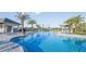 Community pool with zero entry, palm trees, lounge chairs, and poolside pavilion at 16226 Paynes Mill Dr, Bradenton, FL 34211