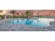 Community pool with shallow end, lounge chairs, and shady cabanas at 16226 Paynes Mill Dr, Bradenton, FL 34211