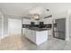 Open kitchen featuring an island, stainless appliances and white cabinetry at 1918 Dixie Ave Ave, Punta Gorda, FL 33950