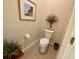 Bright bathroom featuring a toilet, neutral tile, and decorative accents for a cozy feel at 193 Montelluna Dr, North Venice, FL 34275
