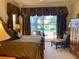 Comfortable bedroom featuring a king bed and access to the pool and outdoor space at 193 Montelluna Dr, North Venice, FL 34275