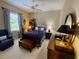 Cozy bedroom with a king bed, armchair, and a dark wood dresser at 193 Montelluna Dr, North Venice, FL 34275