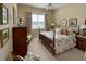Bright bedroom featuring neutral walls, floral bedding, and natural lighting at 193 Montelluna Dr, North Venice, FL 34275