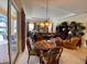 Dining room with a table for six and a view through sliding glass doors to the pool area at 193 Montelluna Dr, North Venice, FL 34275