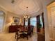 Dining area with a large dining table and chairs, and a decorative chandelier at 193 Montelluna Dr, North Venice, FL 34275