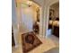 Elegant foyer with tile flooring, decorative rug, and arched doorways at 193 Montelluna Dr, North Venice, FL 34275