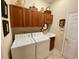 Functional laundry room with cabinets above the washer and dryer and plenty of storage at 193 Montelluna Dr, North Venice, FL 34275