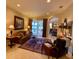 Living room with tiled floors, furniture, and a view through sliding glass doors to the pool area at 193 Montelluna Dr, North Venice, FL 34275