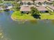 Picturesque aerial view of a home backing onto a tranquil lake, surrounded by lush landscaping at 2064 Batello Dr, Venice, FL 34292
