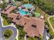 Stunning aerial view of the community clubhouse, pool, and surrounding green spaces, perfect for recreation and relaxation at 2064 Batello Dr, Venice, FL 34292