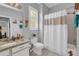 Well-lit bathroom with a shower/tub combo, toilet, and vanity with storage, creating a comfortable space at 2064 Batello Dr, Venice, FL 34292