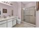 Bright bathroom featuring double sinks and glass enclosed shower at 2064 Batello Dr, Venice, FL 34292