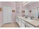 Bathroom featuring double sinks and a large mirror at 2064 Batello Dr, Venice, FL 34292