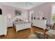 Charming bedroom with pink walls and white furniture at 2064 Batello Dr, Venice, FL 34292