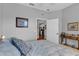 Comfortable bedroom featuring a bed with decorative pillows and views of the kitchen at 2064 Batello Dr, Venice, FL 34292