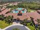 Impressive aerial view of the community clubhouse and pool area, providing residents with resort-style amenities at 2064 Batello Dr, Venice, FL 34292
