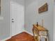 Inviting foyer featuring hardwood floors, elegant console table, and a door leading to interior spaces at 2064 Batello Dr, Venice, FL 34292