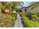Charming home exterior with lush landscaping and a tile roof at 2064 Batello Dr, Venice, FL 34292