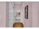 Hallway leading to a bright bathroom with white vanity at 2064 Batello Dr, Venice, FL 34292