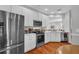 Bright kitchen features white cabinetry, stainless steel appliances, and granite countertops at 2064 Batello Dr, Venice, FL 34292