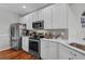 Bright kitchen features white cabinetry, stainless steel appliances, and granite countertops at 2064 Batello Dr, Venice, FL 34292