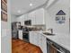 Bright kitchen features white cabinetry, stainless steel appliances, and granite countertops at 2064 Batello Dr, Venice, FL 34292