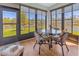 Enclosed lanai offers serene lake views through large windows at 2064 Batello Dr, Venice, FL 34292