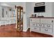 Living room featuring hardwood floors, an entertainment center and views of the kitchen at 2064 Batello Dr, Venice, FL 34292