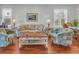 Comfortable living room with plush seating, wood floors, and bright windows at 2064 Batello Dr, Venice, FL 34292